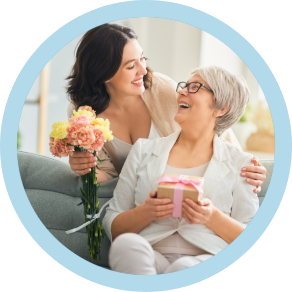 woman handing flowers to an older woman